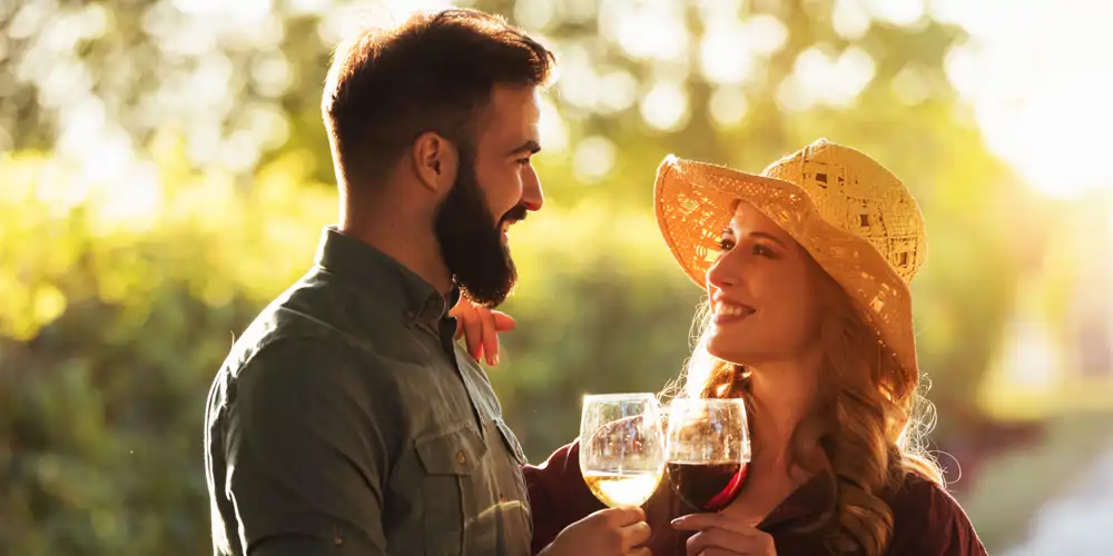 happy couple sharing a glass of wine at a wine tasting