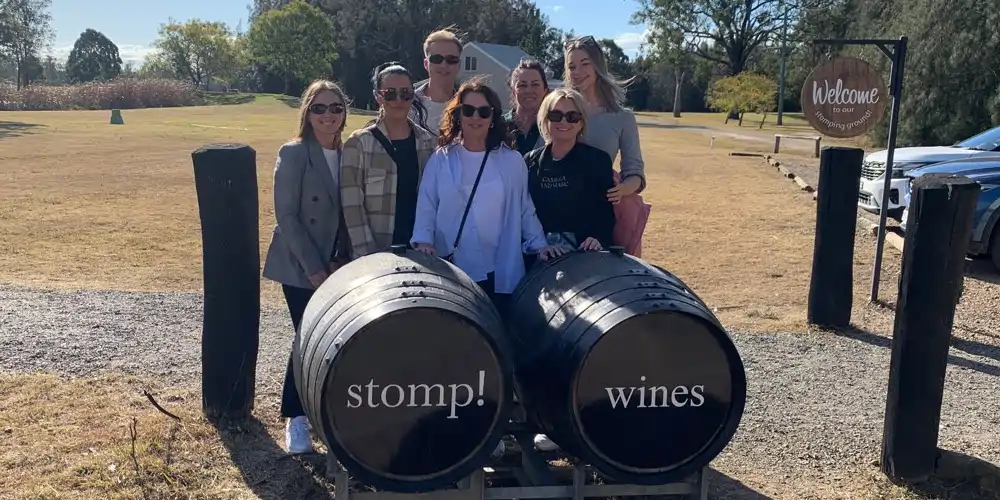 group of seven friends on a wine tour dressed chic casual